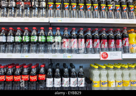 Supermarket fridges displaying a range of sugary fizzy drinks Stock Photo