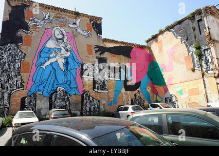 Large mural 'Holy Mother and Child', on the side wall of a building adjacent to a car park, Ancona. Stock Photo