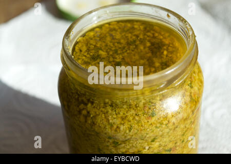 a jar of homemade sicilian pesto with pinenuts basil dry tomatoes and oil Stock Photo