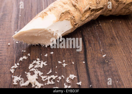 Grated raw horse radish on a wooden table Stock Photo
