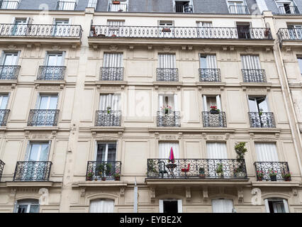 French Balconies in Paris with flowers. Stock Photo