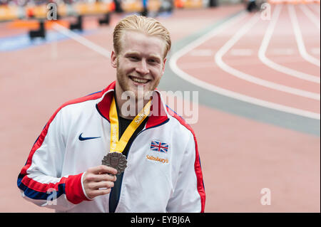 London, UK. 26 July 2015. Jonnie Peacock (GBR) poses with his medal after finishing second in the 100m Men - T44 at the Sainsbury's IPC Grand Prix Final which took place at the Queen Elizabeth Olympic Park in Stratford. Credit:  Stephen Chung / Alamy Live News Stock Photo