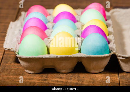 Paper egg carton of colorful naturally dyed Easter eggs Stock Photo