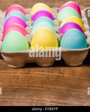 Paper egg carton of colorful naturally dyed Easter eggs Stock Photo