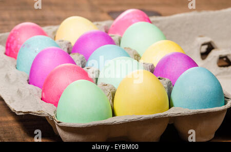 Paper egg carton of colorful naturally dyed Easter eggs Stock Photo