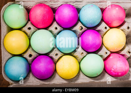 Paper egg carton of colorful naturally dyed Easter eggs Stock Photo