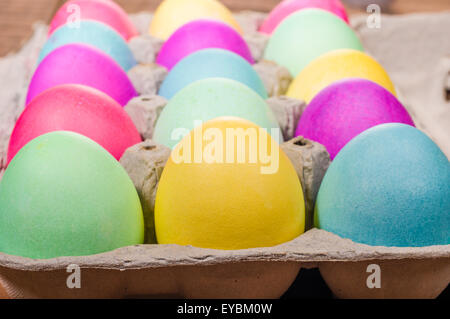 Paper egg carton of colorful naturally dyed Easter eggs Stock Photo