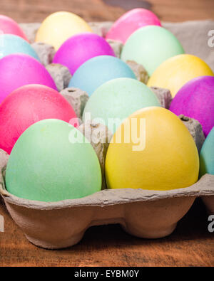 Paper egg carton of colorful naturally dyed Easter eggs Stock Photo