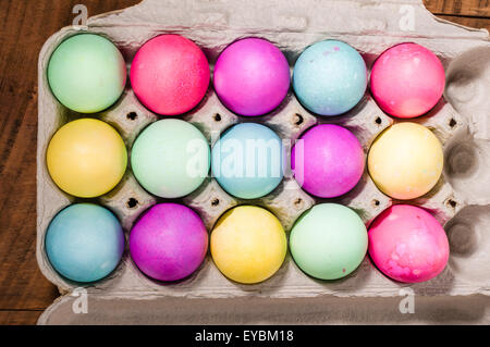Paper egg carton of colorful naturally dyed Easter eggs Stock Photo