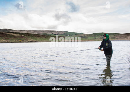 A teenage boy fishing for trout at the Dinas Fishery, Ceredigion mid Wales UK Stock Photo