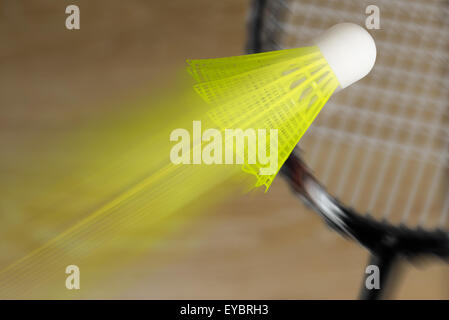 Yellow shuttlecock and racket badminton in flight Stock Photo