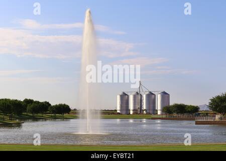 Grain Silos by Lake with Fountain Stock Photo