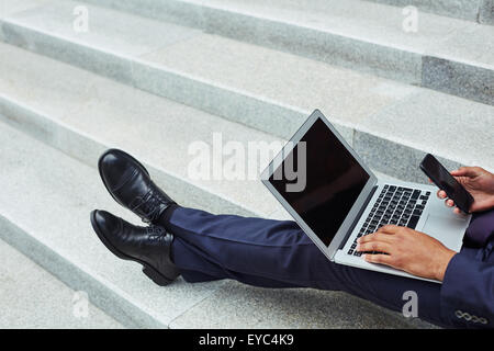 Modern employee using mobile gadgets Stock Photo