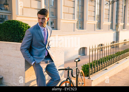 Handsome businessman standing outdoors in town Stock Photo