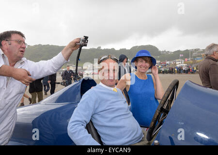 Sunbeam 350 hp commemorative run at Pendine sands, July 2015. Driven by Don Wales, grandson of Sir Malcolm Campbell. Claire Meadows, Bluebird fan, is with Don Wales in this image. Stock Photo