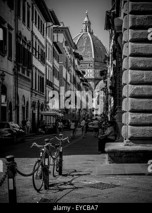 Filippo Brunelleschi's dome on Florence Cathedral glimpsed between buildings in the city of Florence, Italy. Stock Photo