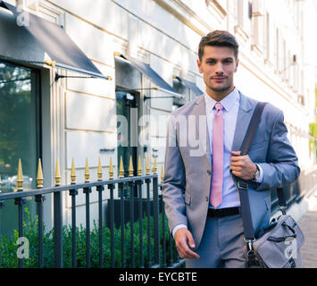 Portrait of a handsome young businessman walking in the city Stock Photo
