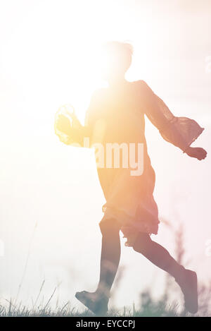 Woman Running to Freedom Through Countryside Field, Silhouette of Female Person, Double Exposure, Vintage Retro Tone Effect.
