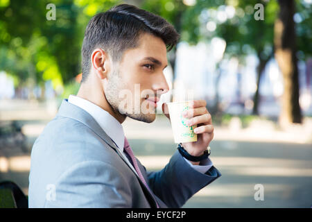 Portrait of a handsome businessman drinking coffee outdoors Stock Photo