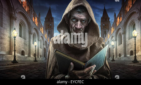 Monk - priest   front of the church holding the Bible Stock Photo