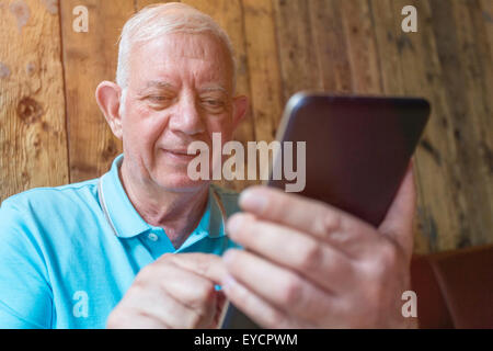 Portrait of senior man using phablet Stock Photo