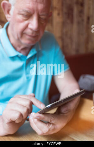 Senior man using phablet Stock Photo