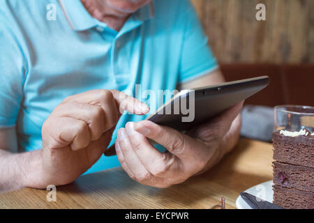 Senior man using phablet, close-up Stock Photo