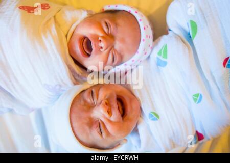 Twin baby sister and brother crying Stock Photo