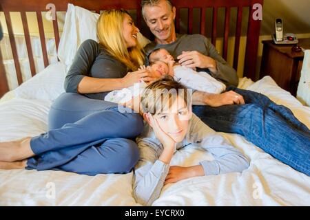 Couple with son and newborn twin girl and boy Stock Photo