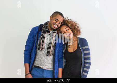 Studio portrait of romantic couple with heads on each others shoulder Stock Photo