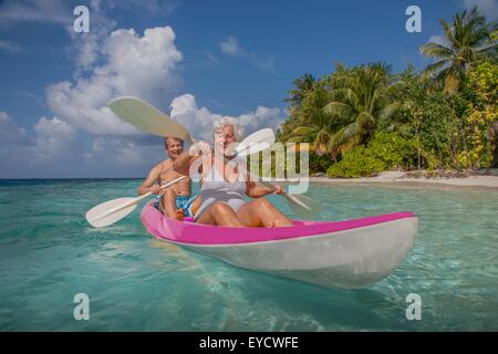 Senior couple in canoe, Maldives Stock Photo