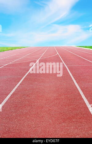 detail of a running track towards the horizon and blue sky Stock Photo