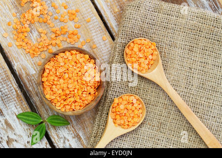 Uncooked red lentils on rustic wooden surface Stock Photo