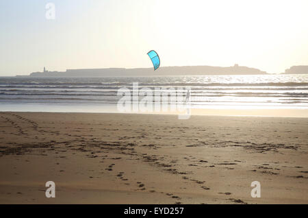 Kite surfing on Essaouira beach, with the old prison on the Island of Mogador behind, in Morocco, North Africa Stock Photo