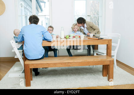 Family at breakfast table in kitchen Stock Photo