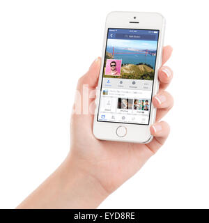 Varna, Bulgaria - February 02, 2015: Female hand holding Apple Silver iPhone 5S with Facebook application on the screen. Stock Photo