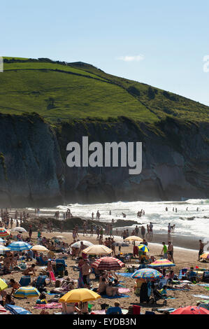 Sunbathing At Itzurun Beach, Zumaia, Basque Country, Spain Stock Photo