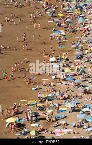 People Sunbathing At Itzurun Beach, Zumaia, Basque Country, Spain Stock Photo