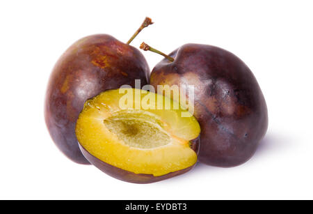 Two violet plums and half isolated on white background Stock Photo