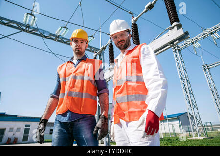 Portrait of two engineers against electricity substation Stock Photo