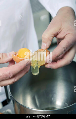 Separating egg yolk and egg white Stock Photo