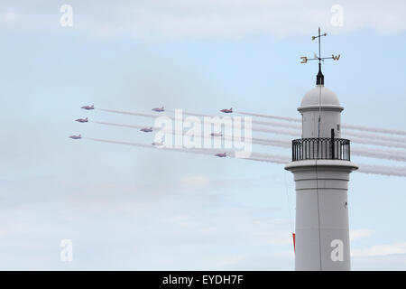The Royal Air Force Red Arrows fly past Seaburn Lighthouse during Sunderland International Airshow. The Hawk T1 jet aircraft tra Stock Photo