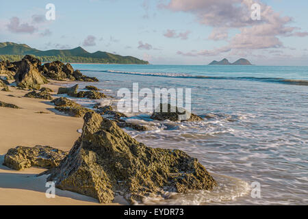 Rock outcropping at the shore of Bellows Beach at dawn on Waimanalo Bay on Oahu, Hawaii Stock Photo