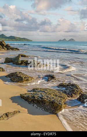 Rock outcropping at the shore of Bellows Beach at dawn on Waimanalo Bay on Oahu, Hawaii Stock Photo