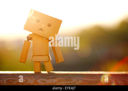 A Manga Japanese toy Danbo Danboard robot character posed for a portrait picture on a warm sunny morning. is a fictional cardboard box robot character Stock Photo