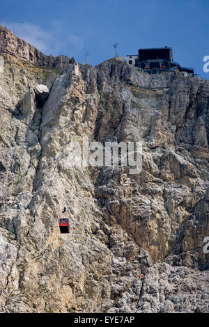 rom Passo Falzarega (Pass), a cable car gondola ascends the rock face of Lagazuoi  (3,244 m), a Dolomites mountain in south Tyrol, Italy.  One of two gondolas rises to the Lagazuoi (2,835), which was the object of heavy combat in World War I. Lagazuoi is a mountain in the Dolomites of northern Italy, lying at an altitude of 2,835 metres (9,301 ft), about 18 kilometres (11 mi) southwest by road from Cortina d'Ampezzo in the Veneto Region. It is accessible by cable car and contains the Refugio Lagazuoi, a mountain refuge situated beyond the northwest corner of Cima del Lago. Stock Photo