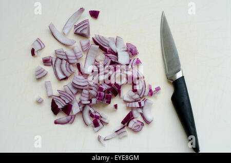 Chopped red onion on a chopping board with knife Stock Photo