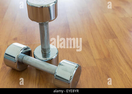 Dumbbells on Wooden Floor Stock Photo