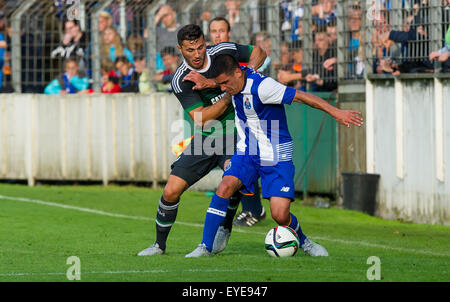 Guetersloh, Germany. 27th July, 2015. Schalke's Sead Kolasinac (l) and Porto's Maxi Pereira compete for the ball during a friendly between German soccer club FC Schalke 04 and Portugal's FC Porto in Guetersloh, Germany, 27 July 2015. Photo: GUIDO KIRCHNER/dpa/Alamy Live News Stock Photo