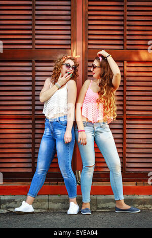 Best friends are dressed in the style of pin-up. Girls laugh. The concept of true friendship. Stock Photo